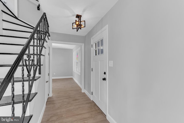 interior space featuring an inviting chandelier and light wood-type flooring