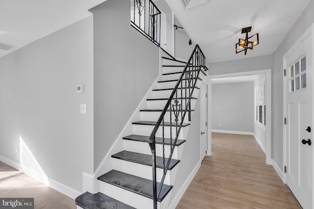 stairs with hardwood / wood-style floors