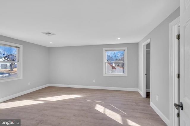 empty room with light hardwood / wood-style flooring