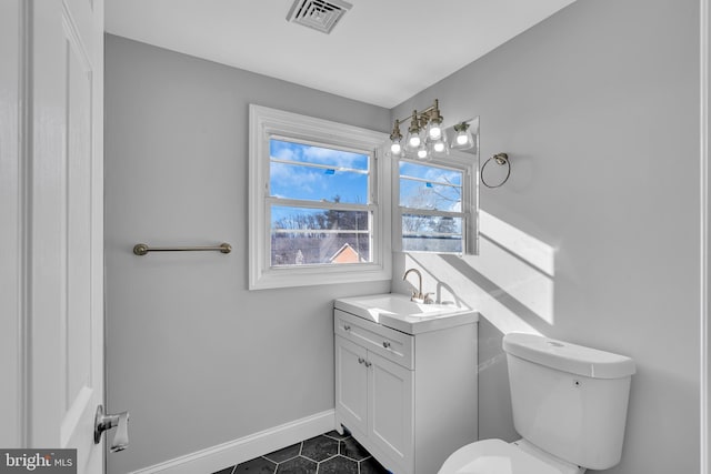 bathroom featuring tile patterned floors, vanity, and toilet