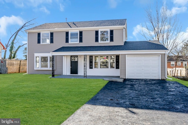 front of property with a garage and a front lawn