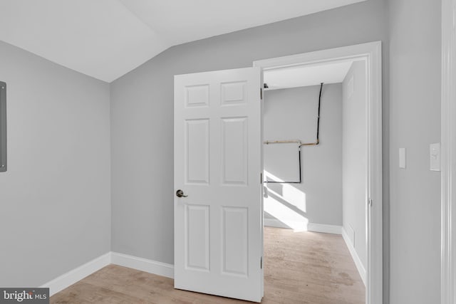 interior space featuring vaulted ceiling and light wood-type flooring