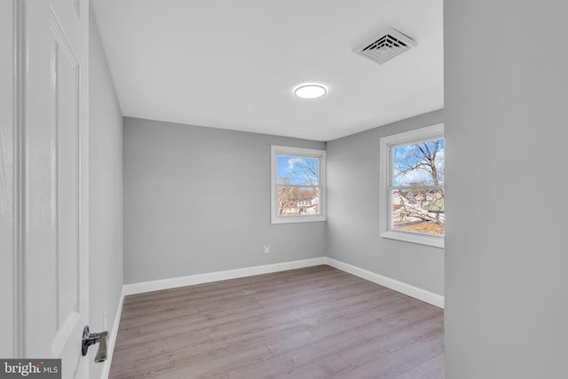 empty room with light hardwood / wood-style flooring