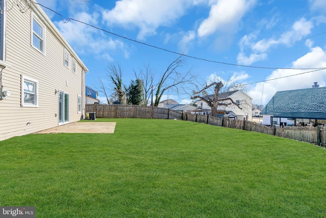 view of yard with central AC and a patio area