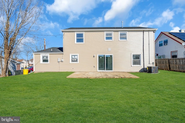 rear view of house with a yard, central air condition unit, and a patio area