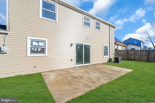 back of property featuring cooling unit, a lawn, and a patio area