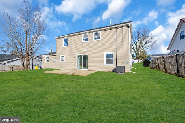 back of house with central AC unit, a yard, and a patio area