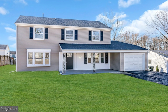 view of property featuring a garage and a front yard