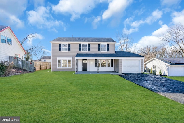 front facade featuring a garage, a front lawn, and covered porch