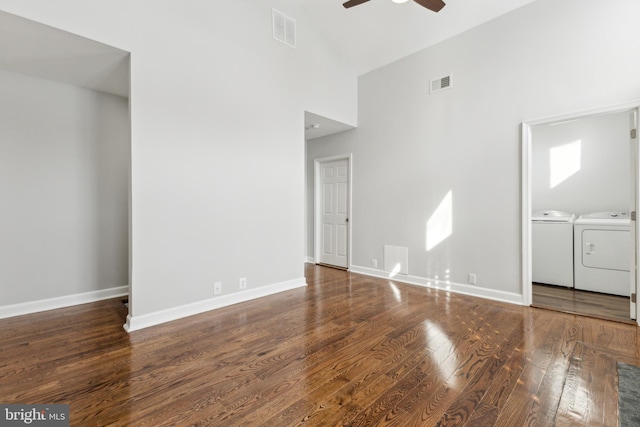 unfurnished living room with high vaulted ceiling, washer and clothes dryer, ceiling fan, and dark wood-type flooring