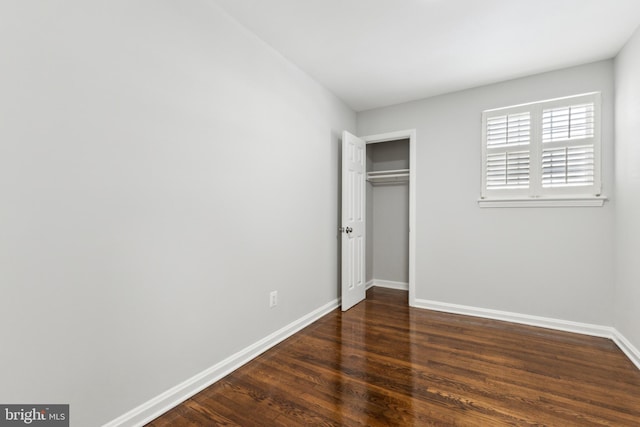 unfurnished bedroom with dark hardwood / wood-style floors