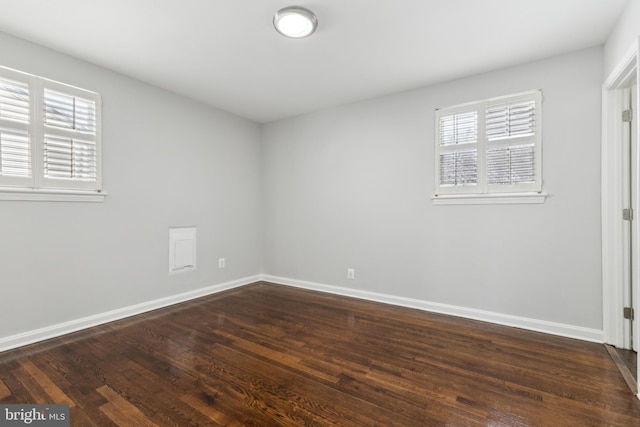 empty room with dark hardwood / wood-style floors