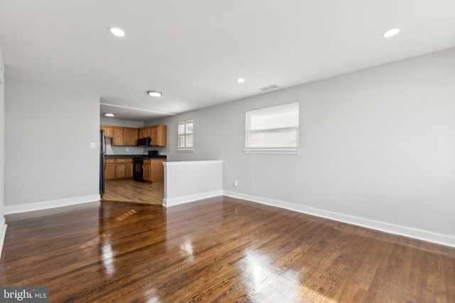 unfurnished living room featuring dark hardwood / wood-style floors