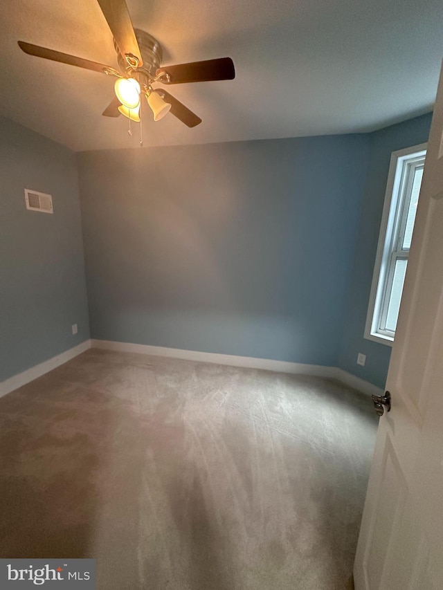 spare room featuring carpet floors and ceiling fan