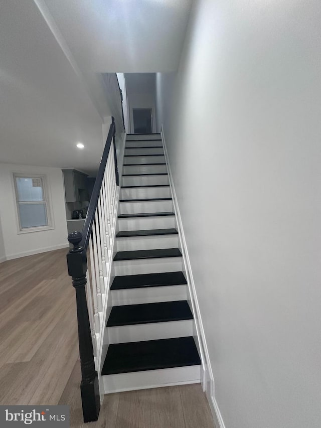 stairs with hardwood / wood-style flooring