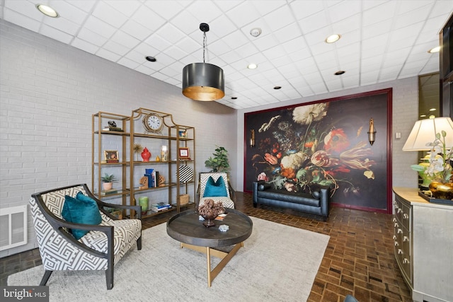 sitting room with a drop ceiling