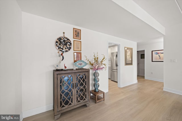 hallway with light hardwood / wood-style floors