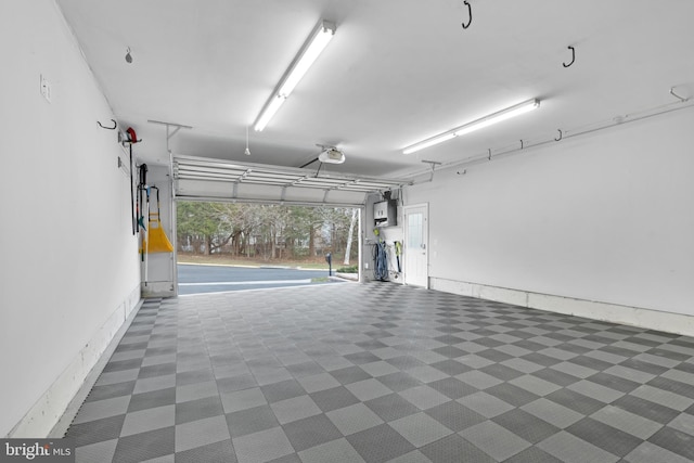 garage featuring a garage door opener and electric panel