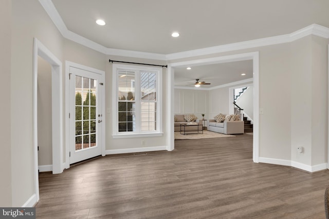 interior space with hardwood / wood-style flooring, ceiling fan, and ornamental molding