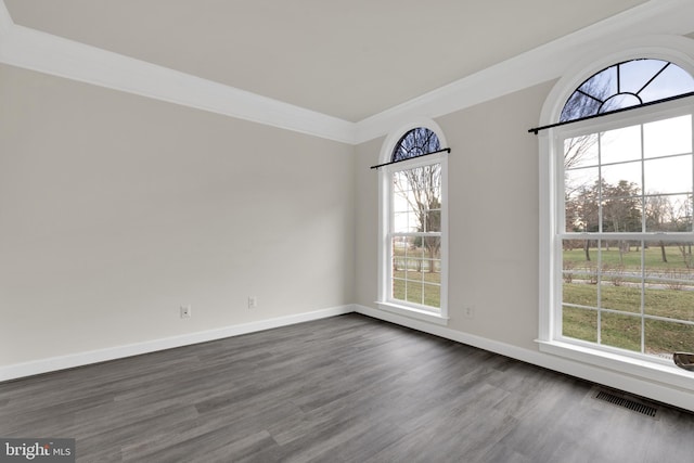 unfurnished dining area with dark wood-type flooring and crown molding