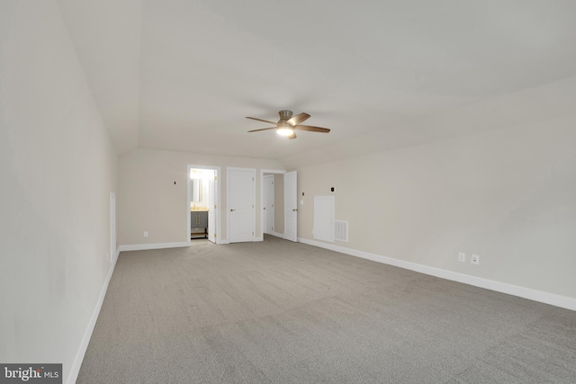 carpeted empty room featuring lofted ceiling and ceiling fan