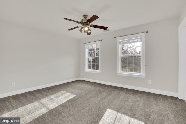 unfurnished room featuring ceiling fan and carpet