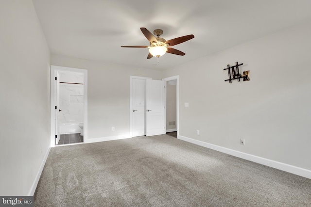 unfurnished bedroom featuring ensuite bath, ceiling fan, and carpet