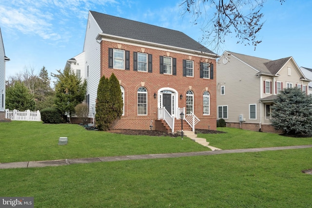 colonial-style house with a front yard