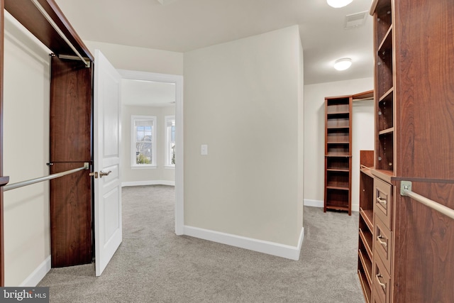 spacious closet with light colored carpet