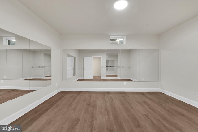 unfurnished room with wood-type flooring