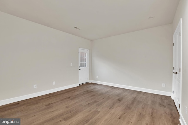 spare room featuring wood-type flooring