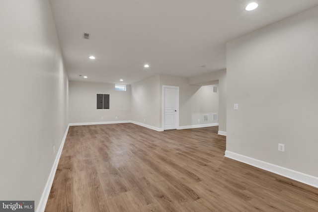 unfurnished room with electric panel and light hardwood / wood-style flooring