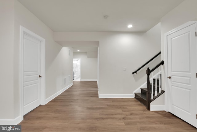 staircase with wood-type flooring