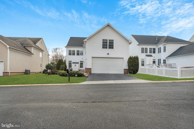 front of property with a garage and a front lawn