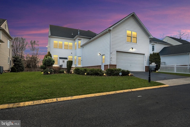 front of property with cooling unit, a lawn, and a garage