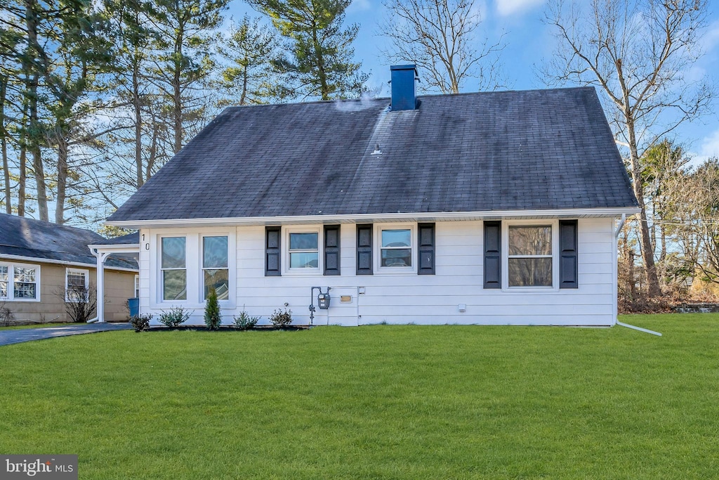 10 Meadowlark Ln, Willingboro, NJ 08046 - view of front of property with a garage, a chimney, and a front yard