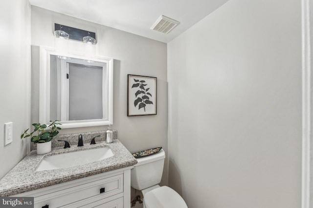 bathroom with toilet and vanity