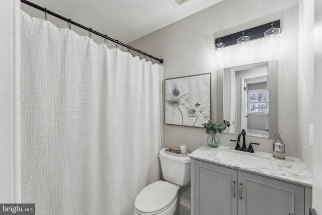 bathroom featuring toilet and vanity