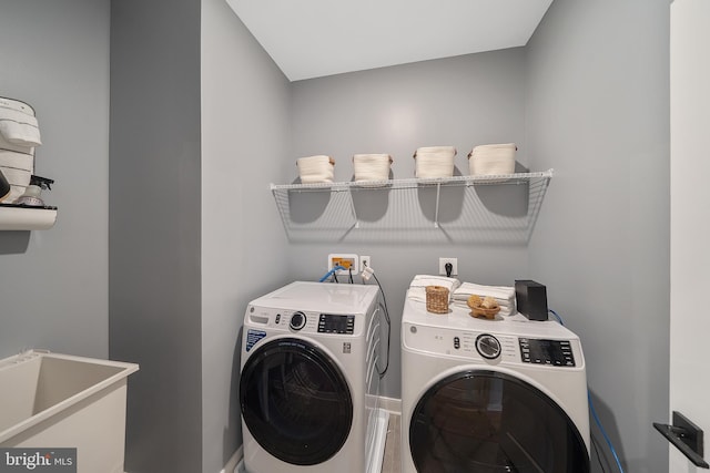 clothes washing area with sink and washing machine and clothes dryer