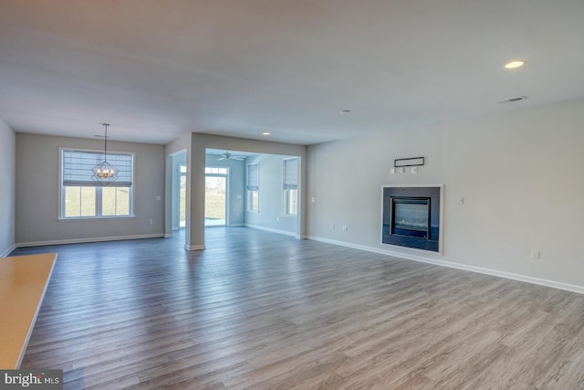 unfurnished living room featuring ceiling fan and wood-type flooring