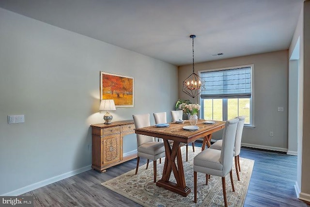 dining room featuring wood-type flooring and a notable chandelier