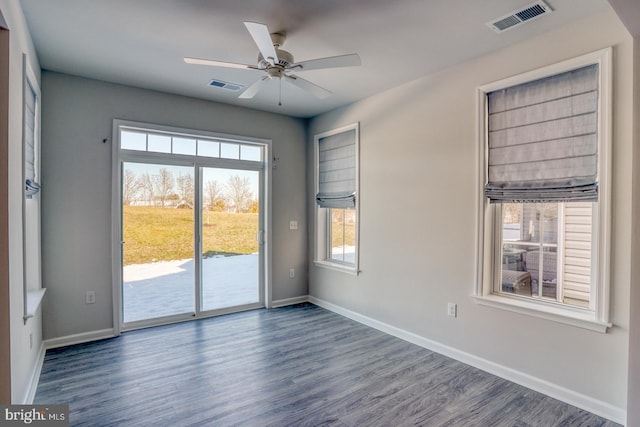 empty room with ceiling fan and dark hardwood / wood-style floors