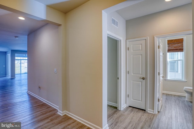 corridor with light wood-type flooring