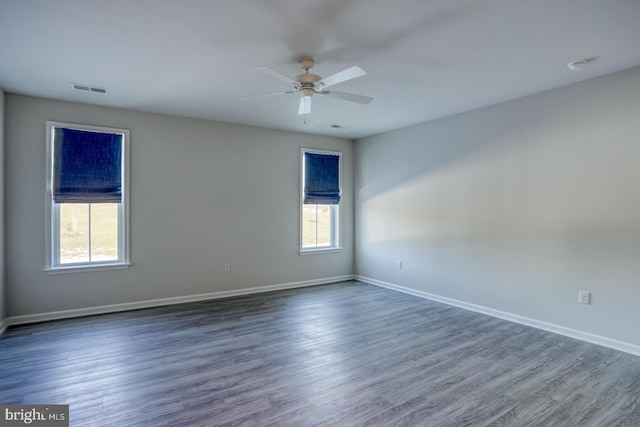 unfurnished room featuring ceiling fan and dark hardwood / wood-style floors