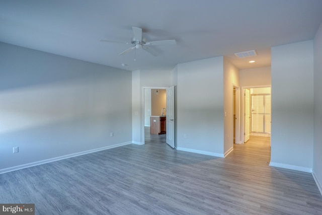 unfurnished room with ceiling fan and hardwood / wood-style floors