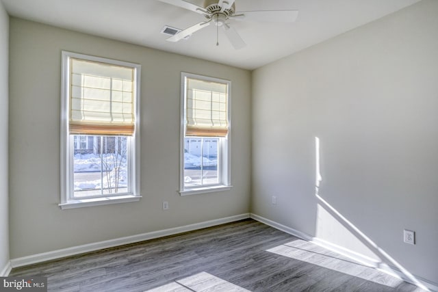 spare room with ceiling fan and wood-type flooring