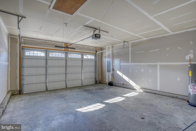 garage featuring electric panel, water heater, and a garage door opener