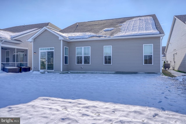 snow covered rear of property with central AC