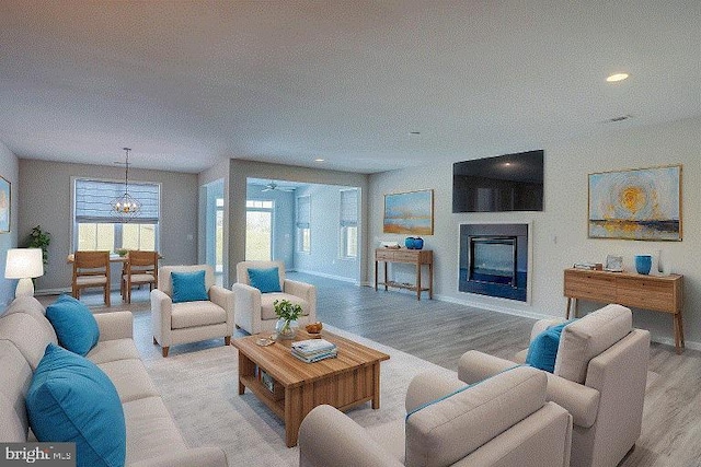 living room featuring light wood-type flooring and an inviting chandelier