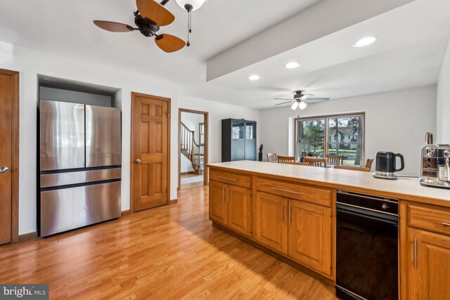 kitchen featuring stainless steel refrigerator, ceiling fan, and light hardwood / wood-style flooring